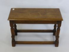 An Oak Occasional Table, with turned legs and straight stretchers.