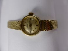 A Lady's 484 14 Ct Yellow Gold Omega Watch, the watch on 14 ct strap having a silvered face with