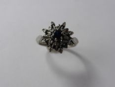 A 9 Ct Yellow Gold Diamond and Sapphire Flower Star form Ring, sapp 3.6 mm, 16 x 1 pt 8 cut dias,