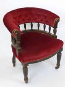 A Gentleman's Edwardian Tub Chair, with spindle back supports, covered in red velvet upholstery.