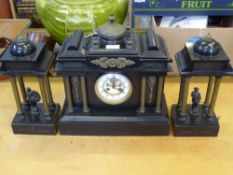 A Black Slate Architectural Mantel Clock with Garniture, the mechanism stamped JJS, the plinth