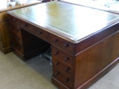 A Mahogany Partner's Desk, a central long drawer with four short drawers to one side, a central long