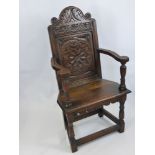 An Antique Oak Carved Hall Chair, with decorative floral motif to chair back, on turned legs and