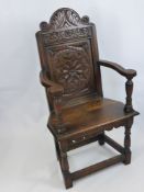 An Antique Oak Carved Hall Chair, with decorative floral motif to chair back, on turned legs and