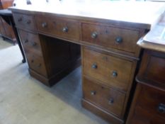 An Edwardian Leather Top Oak Partner's Twin Pedestal Desk, the desk having three drawers to either