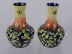 A Pair of Ceramic Vases, with floral and butterfly design, approx 16 cms