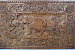 A Carved Wooden Panel, depicting an Indian Elephant and Mahout, approx 68 x 41 cms.