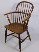 An Antique Oak Spindle Back Windsor Arm Chair, turned legs and straight stretchers.