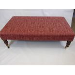 A Large Reproduction Foot Stool covered in pink fabric, approx 122 x 70 cms, on turned legs with