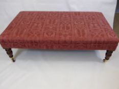 A Large Reproduction Foot Stool covered in pink fabric, approx 122 x 70 cms, on turned legs with