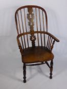 An Antique Elm Spindle Back Windsor Arm Chair, turned legs and straight stretchers.