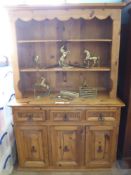 A Pine Dresser, with three drawers and three cupboards beneath, loose top with scalloped edging