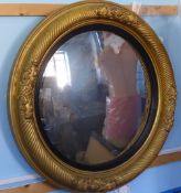 A Late Victorian Circular Convex Mirror, within a gilt wood frame of rope design.