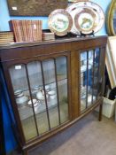 An Edwardian Leslie Belcher (Art House Furniture), glazed bow fronted display cabinet, two glass