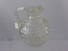 A Hand Blown Glass Water Jug, with bubble inclusions.