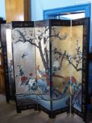 A Decorative Chinese Six Panel Screen, carved with birds and blossom on gold ground to one side