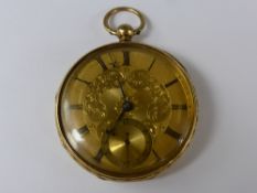 An 18 Ct Gold Open Face Pocket Watch. The watch case having floral engraving, gold engraved face