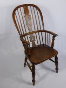 An Antique Elm Spindle Back Windsor Arm Chair, turned legs and straight stretchers.