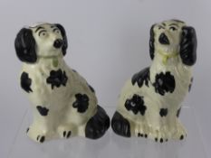 A Pair of Antique Staffordshire Spaniels, hand painted expressions, one 27 cms high and the second