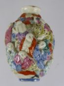 A Chinese Porcelain Hand Painted Perfume Bottle, depicting figures in high relief, with character