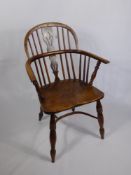 An Antique Elm Spindle Back Windsor Arm Chair, turned legs with curved front stretcher.