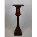 An Arts & Crafts Mahogany Torchere, central column supported on a quadruple plinth with ceramic