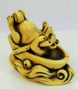 Meiji Period Japanese Netsuke, a comical ivory carved netsuke, depicting a reclining fox punting