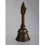 An Antique Mixed Metal Hand Bell, the bell having a ribbed handle with the Hindu deity Lakshmi to