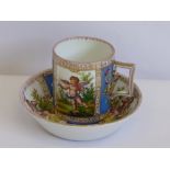 A Dresden Style Mug and Saucer, hand painted with cherubs and floral spray, marked Dresden to base