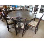 A Round Stained-Oak Antique Drop Leaf Dining Table, on pad feet approx 127 x 156 x 73 cms together