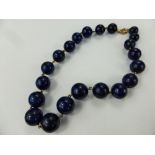 A Graduated Lapis Lazuli and 9 ct gold necklace, approx 38 cms, largest bead approx 15 mm,
