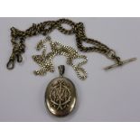 An Antique Silver Locket, having initials in the form of branches to the front together with a solid