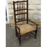 An Antique Oak North Country Spindle Back Chair, with rush seating and front stretcher unusually