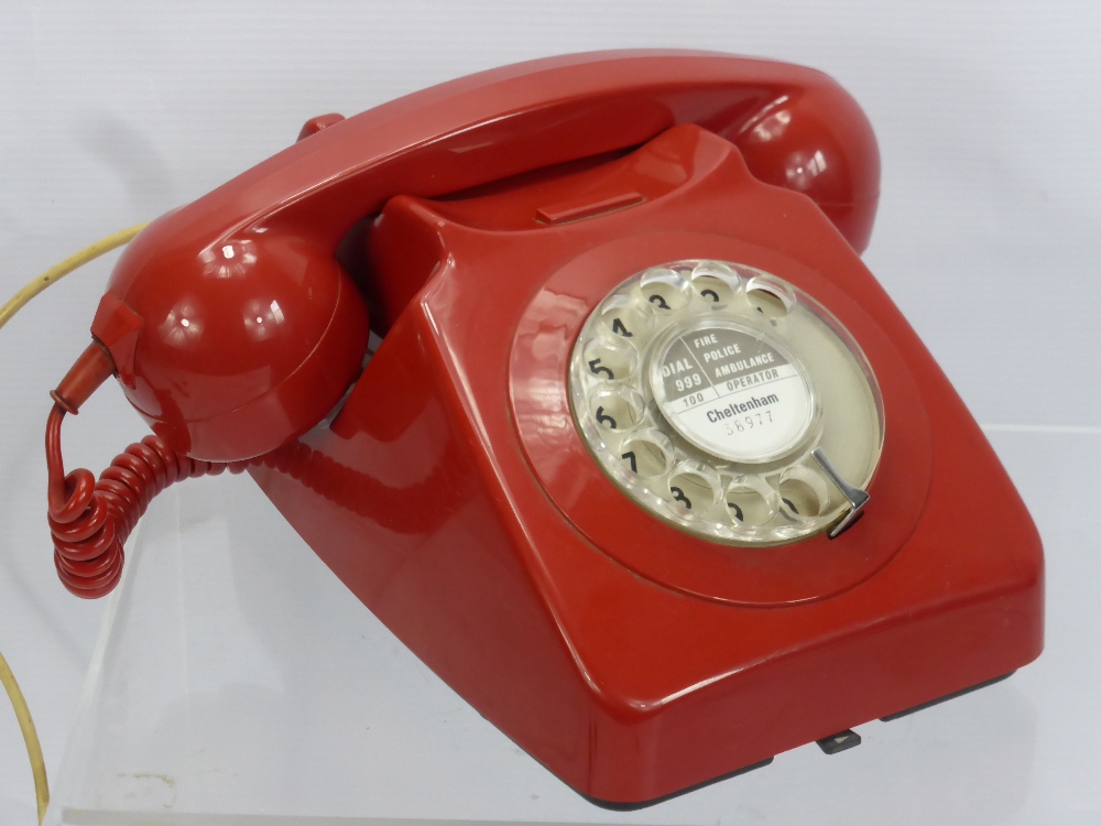 A Vintage Red Rotary Dial Telephone.
