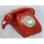 A Vintage Red Rotary Dial Telephone.