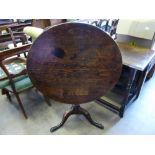 An Antique Oak Tilt Top Table, the table having turned column with hoof feet, approx 79 x 69 cms.