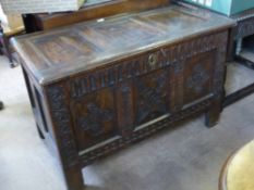 An Antique English Oak Stained Coffer, with decorative carving to front panel with floral carving to