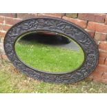 A Victorian Oval Hall Mirror, with decorative carving to the frame depicting thistles and