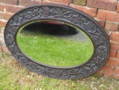 A Victorian Oval Hall Mirror, with decorative carving to the frame depicting thistles and