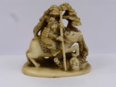 An Antique Japanese Ivory Carved Netsuke, depicting a mounted Samurai warrior slaying another,