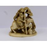 An Antique Japanese Ivory Carved Netsuke, depicting a mounted Samurai warrior slaying another,