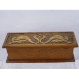 An Oak Stationery Box in the Art Nouveau style with decorative carving, architect's rolling ruler