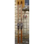 A Pair of Vintage Wooden Skis No. 10 11136 with original leather boot and metal binding.