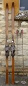 A Pair of Vintage Wooden Skis No. 10 11136 with original leather boot and metal binding.