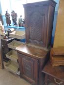 An Antique Oak Double Cupboard in the 17th Century Style, the central panel to both top and bottom