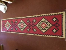 A 20th Century Turkish Tekke Woollen Kilim, of geometric design, maroon, beige and black runner,