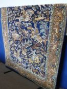 A Persian Style Woollen Carpet, depicting mounted figures hunting, blue and pink on cream ground,