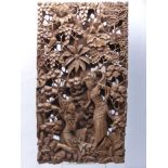 An Indonesian Wooden Carved Panel, depicting a lady huntress in the forest, approx 27 x 50 cms.