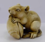 A Meiji Period Japanese Ivory Netsuke, carved as a rat and mussel signature cartouche to the base of