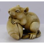 A Meiji Period Japanese Ivory Netsuke, carved as a rat and mussel signature cartouche to the base of